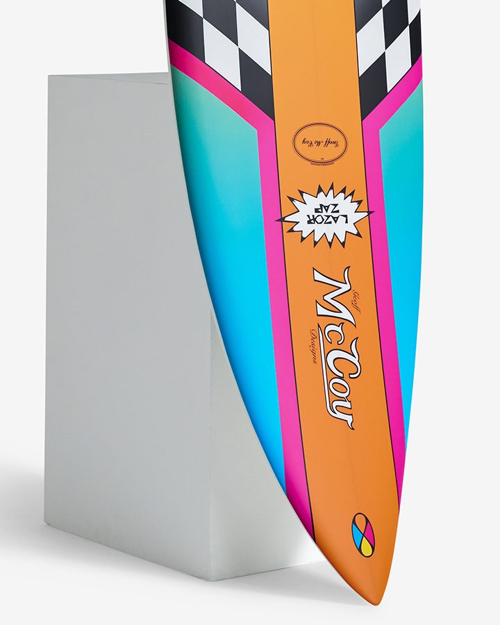 McCoy Lazor Zap surfboard with orange, pink and aqua spray and the Geoff McCoy Designs logo